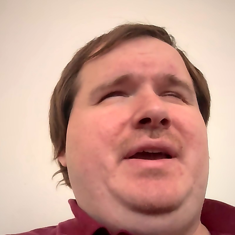 Tony Gebhard — totally blind musician, assistive-technology professional, and advocate, author of No Sight Required; a man with short brown hair and a trimmed beard, wearing a maroon polo shirt.